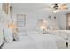 Bright bedroom with a ceiling fan and two beds with white bedding and coastal-themed décor at 1301 Appian Dr, Punta Gorda, FL 33950
