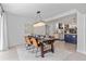 This open dining area features a modern chandelier and a view of the beautiful kitchen at 1301 Appian Dr, Punta Gorda, FL 33950