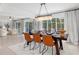 Dining area with a modern chandelier, stylish table setting, and view to the outdoors at 1301 Appian Dr, Punta Gorda, FL 33950