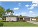 Beautiful single-story home featuring a well-manicured lawn, mature landscaping, and an attached two-car garage at 1301 Appian Dr, Punta Gorda, FL 33950