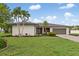 Beautiful single-story home featuring a well-manicured lawn, mature landscaping, and an attached two-car garage at 1301 Appian Dr, Punta Gorda, FL 33950