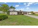 Beautiful single-story home featuring a well-manicured lawn, mature landscaping, and an attached two-car garage at 1301 Appian Dr, Punta Gorda, FL 33950