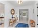 Foyer featuring a table with a decorative mirror and a bench in a well lit room at 1301 Appian Dr, Punta Gorda, FL 33950