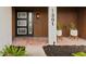 Modern front entrance featuring a black door with frosted windows and a contemporary light fixture at 1301 Appian Dr, Punta Gorda, FL 33950