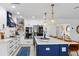 Modern kitchen with white cabinets, stainless steel appliances, an island with pendant lighting, and stylish backsplash at 1301 Appian Dr, Punta Gorda, FL 33950
