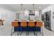 Kitchen island with seating and pendant lights, with modern cabinetry and appliances at 1301 Appian Dr, Punta Gorda, FL 33950