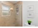 Tiled shower features a shower head and a built-in shelf for toiletries at 1301 Appian Dr, Punta Gorda, FL 33950