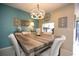 Coastal dining room featuring rustic wood table, chandelier, and decorative coastal accents at 2000 Forrest Nelson Blvd # B4, Port Charlotte, FL 33952