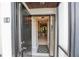 View through the glass front door into the entryway with tile flooring and a view into the living spaces at 2000 Forrest Nelson Blvd # B4, Port Charlotte, FL 33952