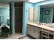 Bright bathroom with a skylight, walk-in shower, and a vanity with ample counter space at 21363 Cottonwood Ave, Port Charlotte, FL 33952