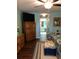 Bedroom with wood floors, blue walls, and a TV mounted above wooden drawers at 21363 Cottonwood Ave, Port Charlotte, FL 33952