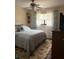 Cozy bedroom featuring a ceiling fan, light-toned walls, and a window that provides natural light at 21363 Cottonwood Ave, Port Charlotte, FL 33952