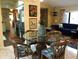 An open dining and living area features a round glass table and tropical-themed chairs at 21363 Cottonwood Ave, Port Charlotte, FL 33952
