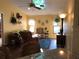Living room featuring comfortable seating, ceiling fan, and natural light at 21363 Cottonwood Ave, Port Charlotte, FL 33952