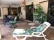 Inviting outdoor patio with lounge chairs, dining set, and well-maintained landscaping at 21363 Cottonwood Ave, Port Charlotte, FL 33952