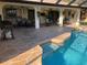 Outdoor pool and patio area with outdoor dining, grill, and lush plants at 21363 Cottonwood Ave, Port Charlotte, FL 33952