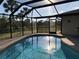 Screened-in pool with sunny backyard views at 21363 Cottonwood Ave, Port Charlotte, FL 33952