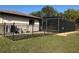 Screened lanai and pool area with metal fencing and well-maintained lawn at 21363 Cottonwood Ave, Port Charlotte, FL 33952