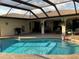 Outdoor pool and lanai area with well-manicured landscape at 21363 Cottonwood Ave, Port Charlotte, FL 33952