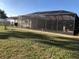 Screened in pool with an outdoor deck and a well maintained lawn at 21363 Cottonwood Ave, Port Charlotte, FL 33952