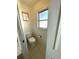 Cozy powder room features neutral tones and a window for natural light at 23395 Mullins Ave, Port Charlotte, FL 33954