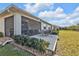 Exterior view of the backyard featuring a patio area, lush lawn, and well-maintained landscaping at 25120 E Lenox Cir, Punta Gorda, FL 33950