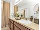 Elegant bathroom featuring double sinks, granite countertops, and a stylish mirror at 25120 E Lenox Cir, Punta Gorda, FL 33950