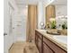 Modern bathroom features a double vanity with granite countertops, a shower, and neutral decor at 25120 E Lenox Cir, Punta Gorda, FL 33950