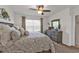 Comfortable bedroom featuring a ceiling fan, window with blinds, and decorative wall art at 25120 E Lenox Cir, Punta Gorda, FL 33950