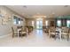 Bright dining area features modern tables, seating, and sunlit windows for a welcoming community space at 25120 E Lenox Cir, Punta Gorda, FL 33950
