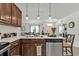 Lovely kitchen features granite counters, wood cabinetry, and open dining area at 25120 E Lenox Cir, Punta Gorda, FL 33950