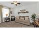 A cozy room featuring a neutral sofa, window with blinds, and a decorative shelf with photos at 25120 E Lenox Cir, Punta Gorda, FL 33950