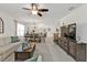 This bright living room features a large sectional sofa and views into the adjacent dining area at 25120 E Lenox Cir, Punta Gorda, FL 33950