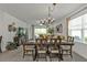 Spacious living room with combined dining area, featuring a large window and modern décor at 25120 E Lenox Cir, Punta Gorda, FL 33950