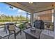Relaxing screened patio with cushioned chairs, a grill, and a view of the backyard at 25120 E Lenox Cir, Punta Gorda, FL 33950