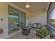 A cozy covered patio with an outdoor seating area, perfect for enjoying the backyard view at 25120 E Lenox Cir, Punta Gorda, FL 33950