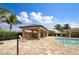 Beautiful community pool featuring a covered pavilion with seating, palm trees, and a sunny atmosphere at 25120 E Lenox Cir, Punta Gorda, FL 33950