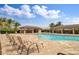 Community pool featuring shaded cabanas and tropical landscaping, creating an inviting outdoor space at 25120 E Lenox Cir, Punta Gorda, FL 33950