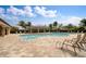 Inviting community pool with lounge chairs and a covered pavilion, perfect for relaxation and social gatherings at 25120 E Lenox Cir, Punta Gorda, FL 33950