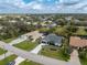 An aerial view of a neighborhood featuring well-maintained homes and landscaping under a partly cloudy sky at 25853 Aysen Dr, Punta Gorda, FL 33983