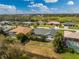 Aerial view of a residential neighborhood, showcasing backyard pools and lush landscaping, with a pond in the distance at 25853 Aysen Dr, Punta Gorda, FL 33983