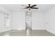 Bright bedroom features tile flooring, fan and closet space at 25853 Aysen Dr, Punta Gorda, FL 33983