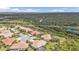 Aerial view of homes near mature trees, water, and roads at 2892 Myakka Creek Ct, Port Charlotte, FL 33953