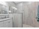 Luxurious bathroom featuring an elegant vanity, a framed mirror, and a seamless glass walk-in shower at 2892 Myakka Creek Ct, Port Charlotte, FL 33953