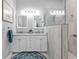 Modern bathroom boasts double sinks, vanity, framed mirrors, and a seamless glass shower at 2892 Myakka Creek Ct, Port Charlotte, FL 33953