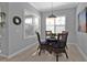 Cozy breakfast nook with a glass table, wicker chairs, plantation shutters, and natural light at 2892 Myakka Creek Ct, Port Charlotte, FL 33953