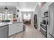 Bright, open kitchen with stainless appliances, a breakfast nook, and wood flooring throughout at 2892 Myakka Creek Ct, Port Charlotte, FL 33953