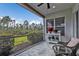 Relaxing screened-in lanai with ceiling fan, potted plants, and view of the beautifully landscaped backyard at 2892 Myakka Creek Ct, Port Charlotte, FL 33953