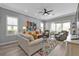Well-lit living room featuring contemporary furnishings, large windows, and a welcoming atmosphere for gatherings at 2892 Myakka Creek Ct, Port Charlotte, FL 33953
