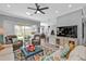 Bright, open living room featuring neutral walls, a ceiling fan, and comfortable seating, creating a cozy atmosphere at 2892 Myakka Creek Ct, Port Charlotte, FL 33953
